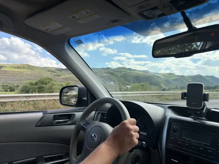 driving through georgian mountains on a sunny day