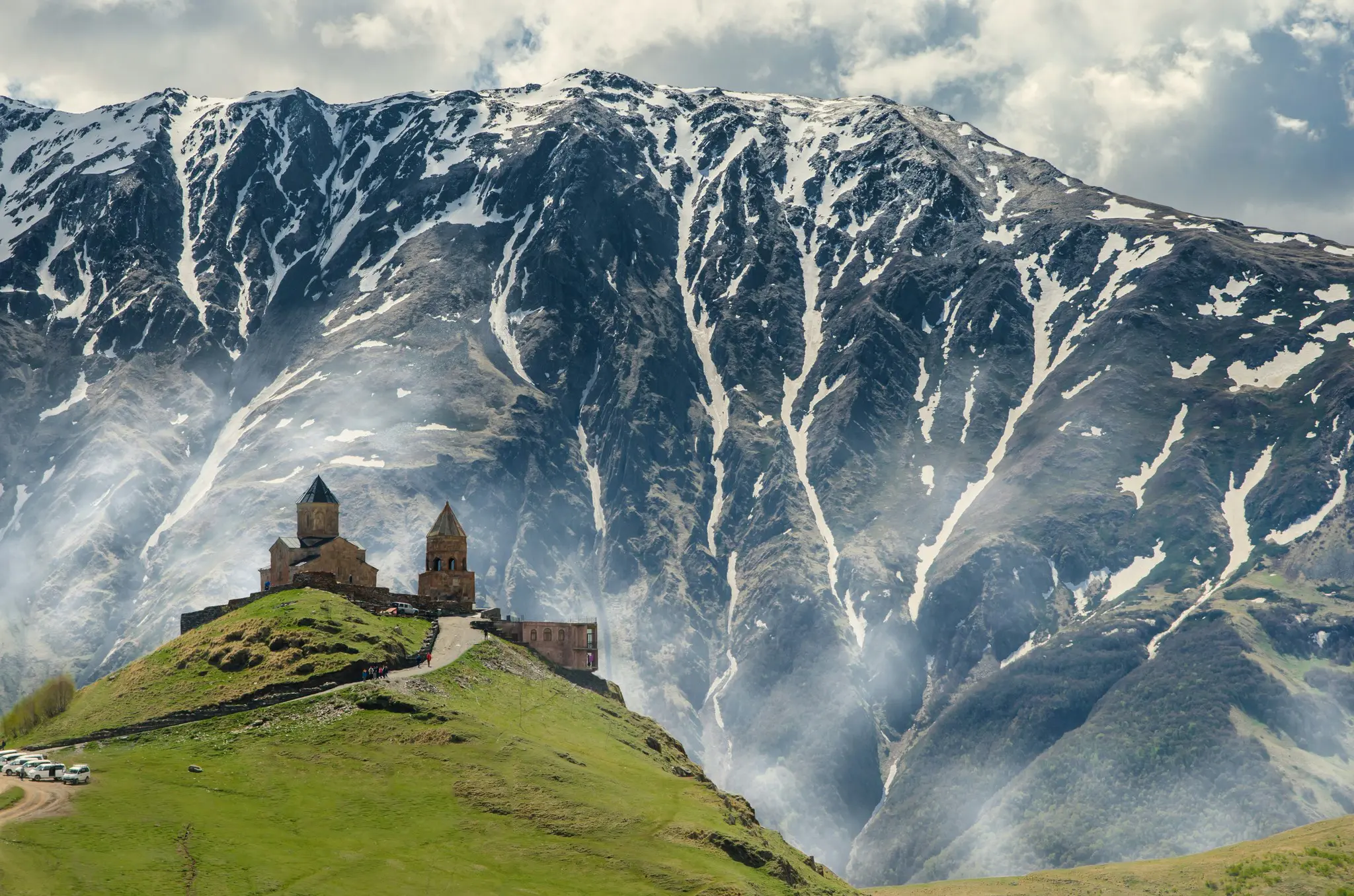 Gergeti Trinity Church against snowy mountains in Georgia